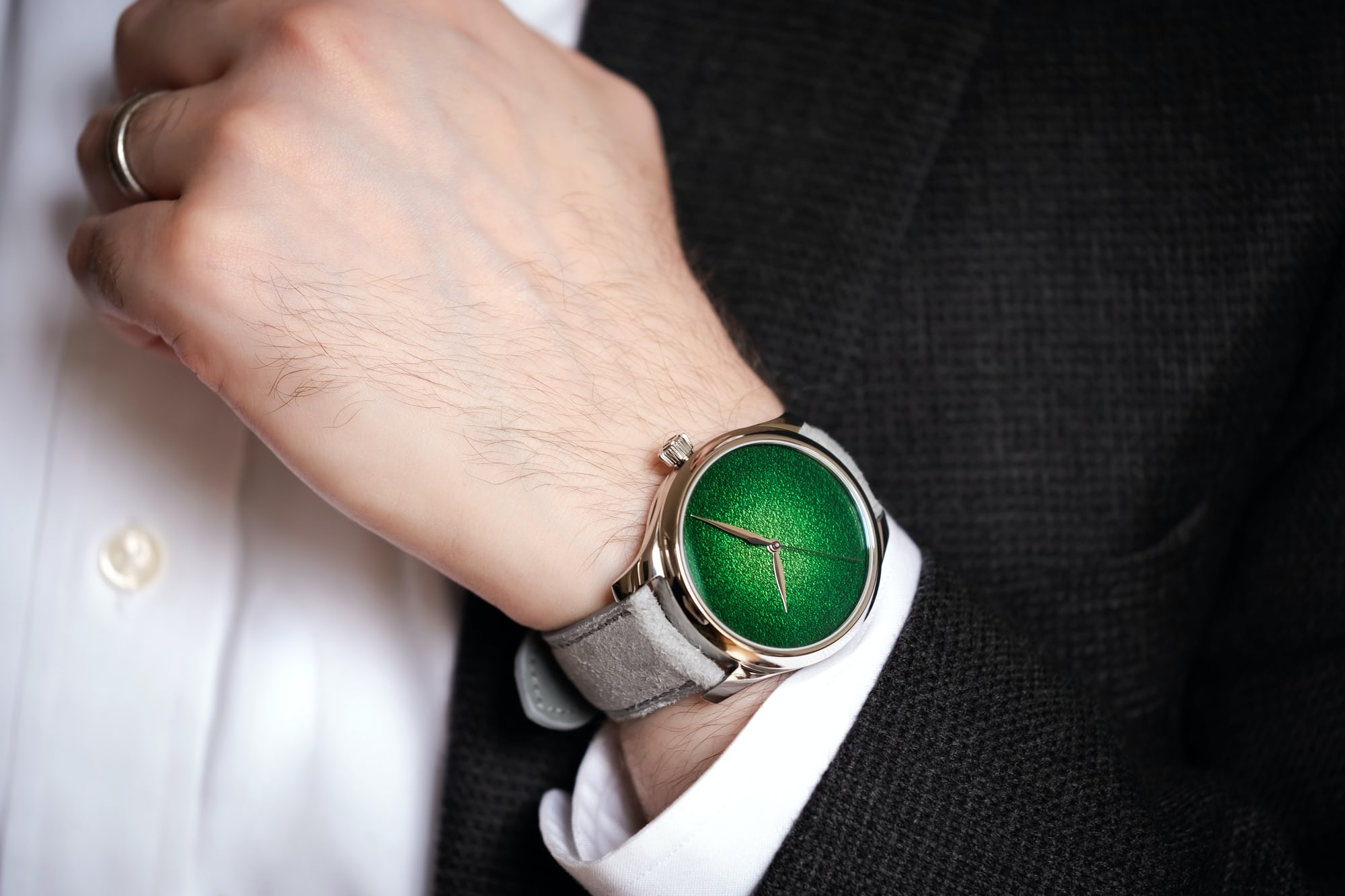 A man wears the H. Moser Centre Seconds Concept Lime Green
